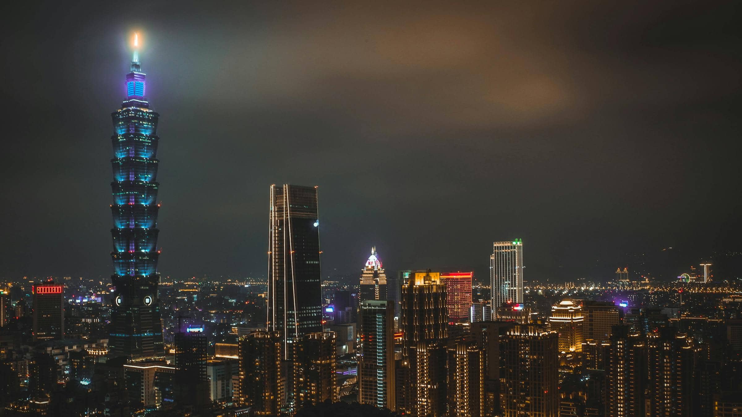 Taipei skyline at night, the lit Taipei 101 cutting through low cloud