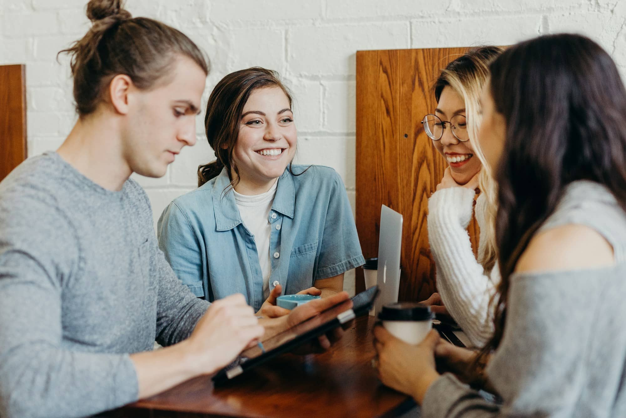 Friends around a table, mid-conversation