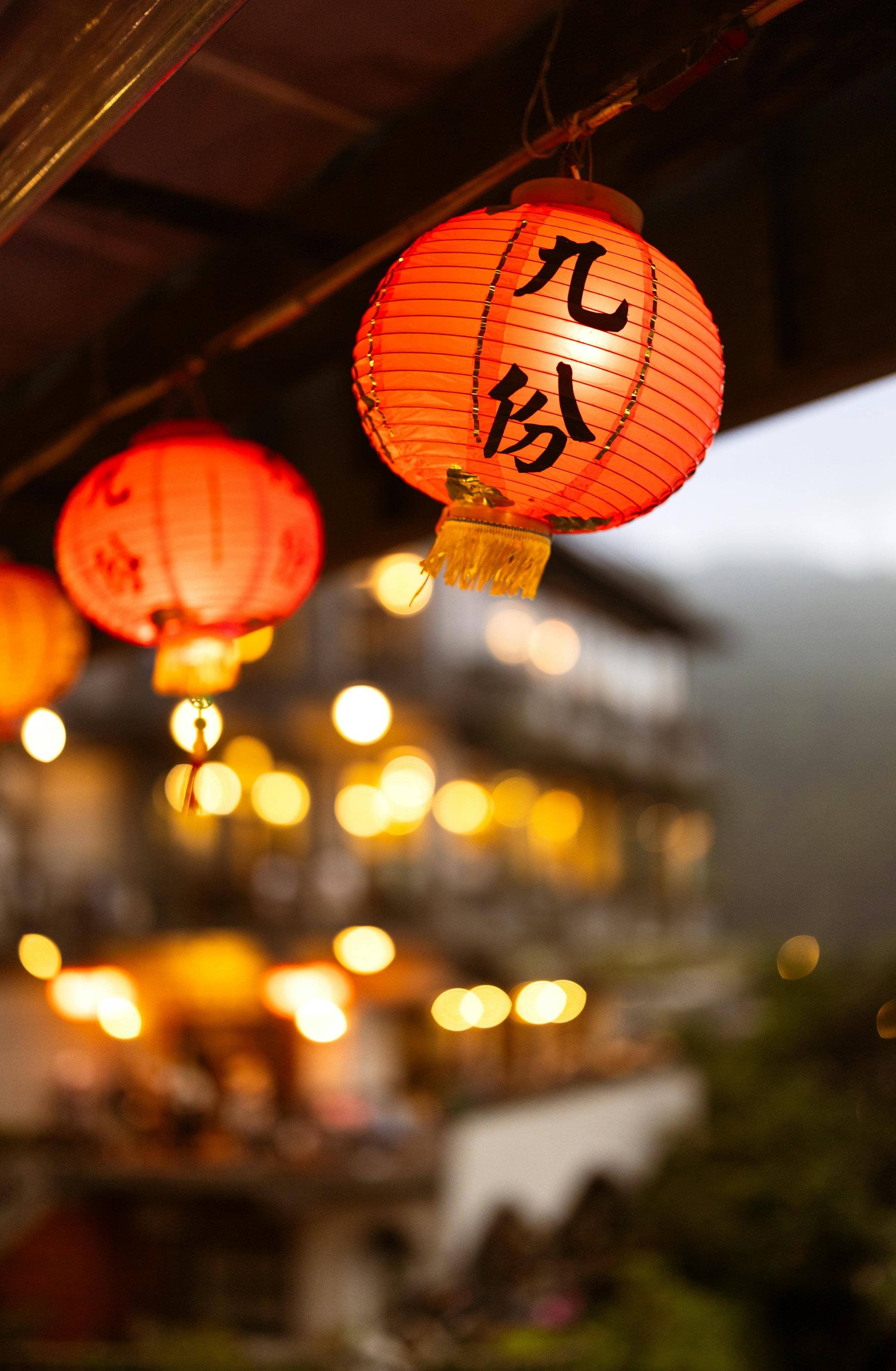 Jiufen at dusk, lanterns glowing along the mountain street